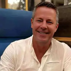 Man in white shirt smiling