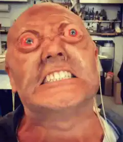 Creepy bald man mask with bulging eyes