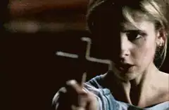 Buffy holds up a cross