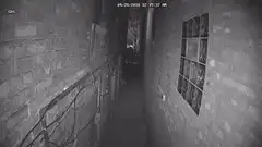 Person walking down dark alley at night