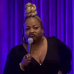 Comedian looking skeptical with microphone
