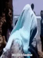 Woman in hijab sitting on couch
