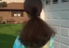 Girl with ponytail turns around smiling