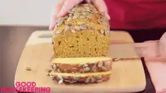 Slicing pumpkin bread with seeds