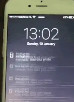 iPhone lock screen with scrolling Instagram notifications