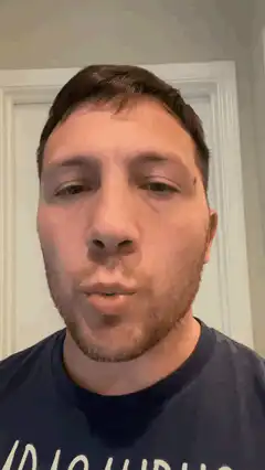 man looking up and chewing