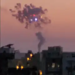 Fireworks exploding over city at dusk