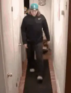 person flips over another person in hallway