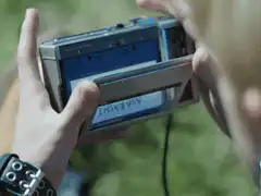Hands inserting a cassette tape