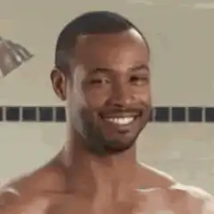 shirtless man smiling in shower