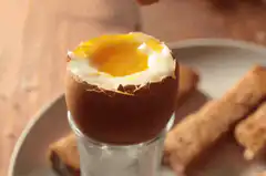 Dipping toast in soft boiled egg