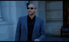 Man removes sunglasses to reveal eyes