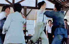 Jackie Chan fighting in a barn