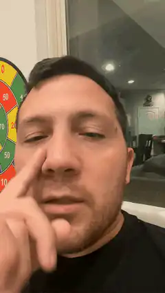 man rubbing nose then looking up