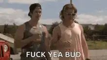 Two guys holding beers saying fuck yea bud