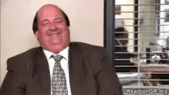 Man in suit smiling and nodding