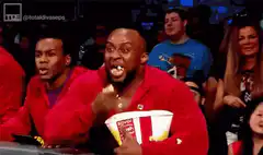 Man eating popcorn with mouth full