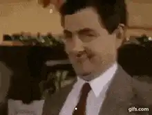 Rowan Atkinson Smirking and Sticking Out Tongue