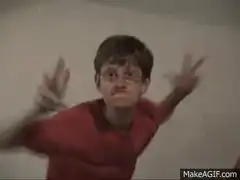 Boy in red shirt making claw hands