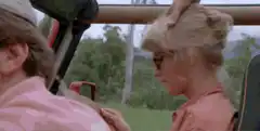 Woman in safari jeep screams at dinosaur