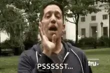 Man making shushing gesture