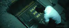 Man looking into open manhole