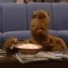ALF eating popcorn and shaking head
