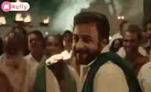 Man passes flaming torch to another man