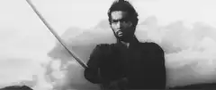Samurai with sword against clouds