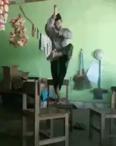 Man dancing on chairs