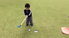 Toddler celebrates sinking a putt