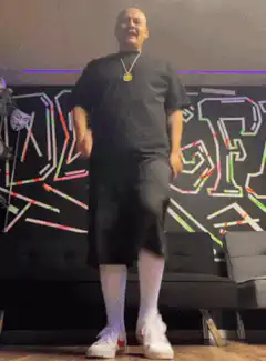 Man in black shirt and white socks dancing