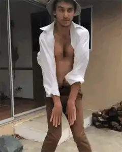 Shirtless man in hat dancing