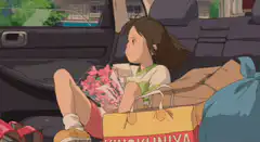 girl sitting in car trunk with shopping bags