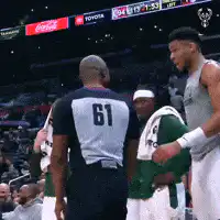 Giannis Antetokounmpo laughs with referee
