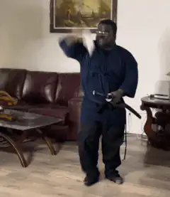 Man in blue gi throwing a knife