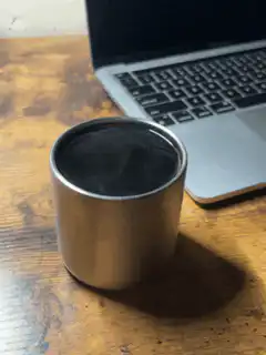 steaming metal cup on desk