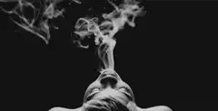 woman exhaling smoke rings