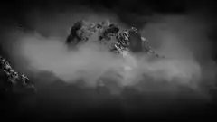 snowy mountain peak in clouds
