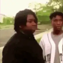 Two guys walking, one points and leaves