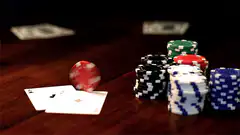 Red poker chip spinning on cards