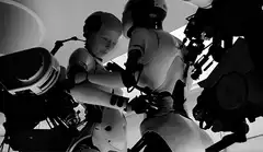 Two robots kissing in black and white
