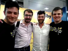 Four men posing together at Alby event