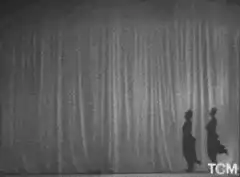 Two men dancing with Bitcoin logos