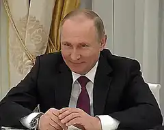 Vladimir Putin smirking and nodding