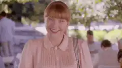 Woman winks and shows phone