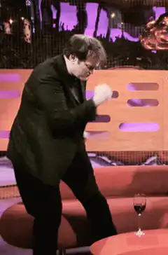 Stephen Fry dancing on stage