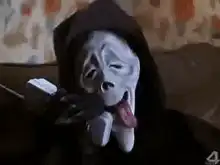 dog wearing mask licking phone