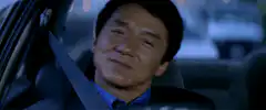Jackie Chan smirking in a car