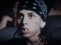 6ix9ine eating popcorn in a movie theater
